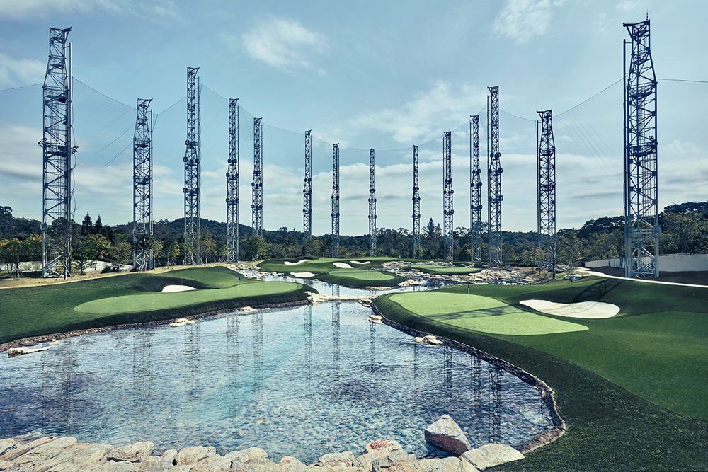 Asheville Synthetic grass golf course with water and tall metal towers