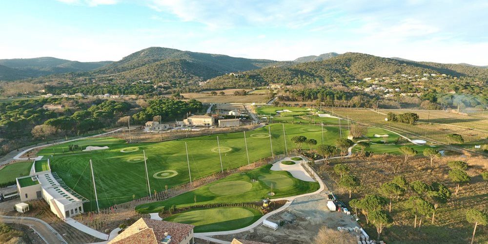 Asheville Aerial view of a synthetic grass golf course surrounded by hills